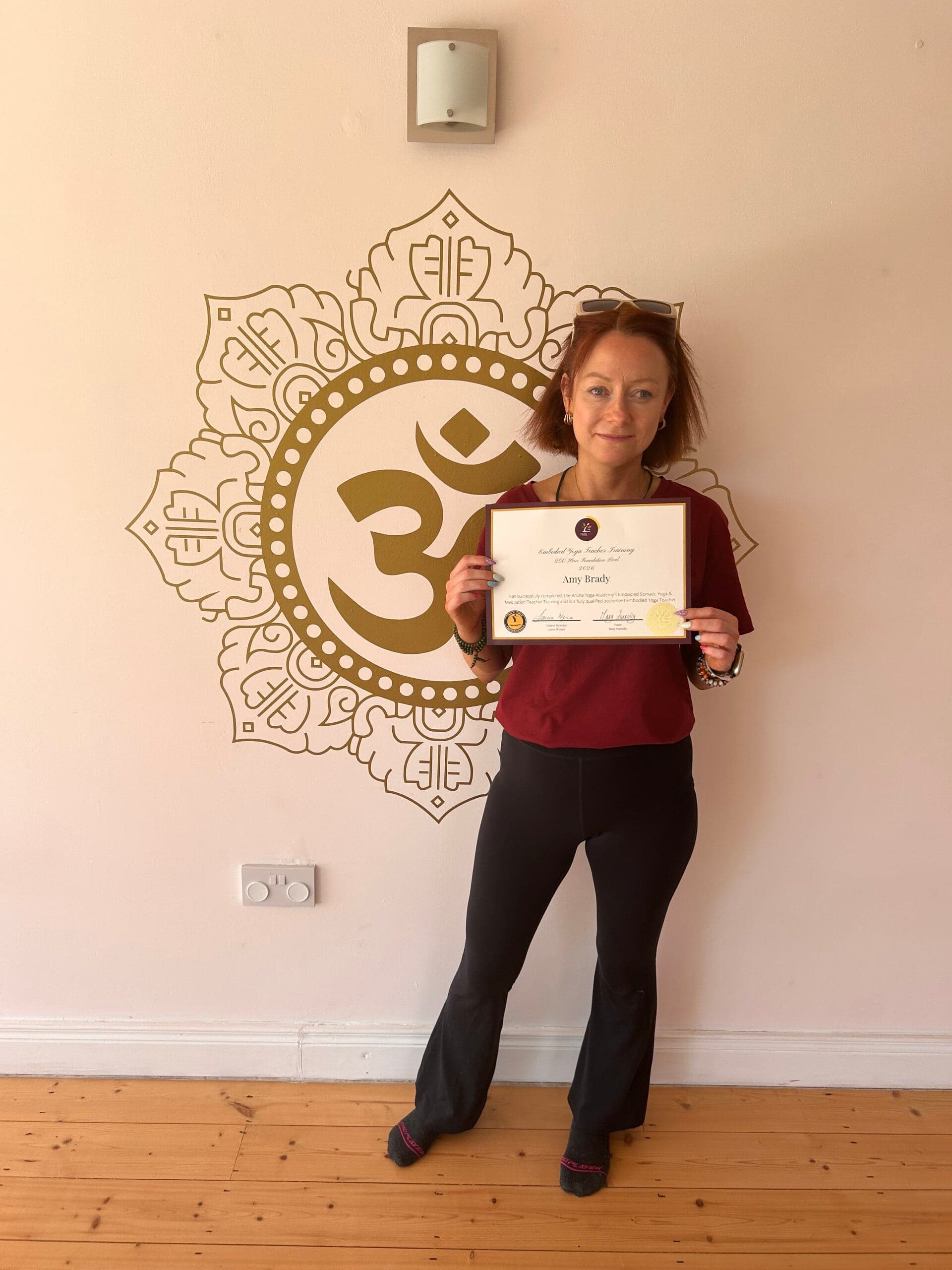 Amy Brady with her Embodied Yoga Teacher Training certificate