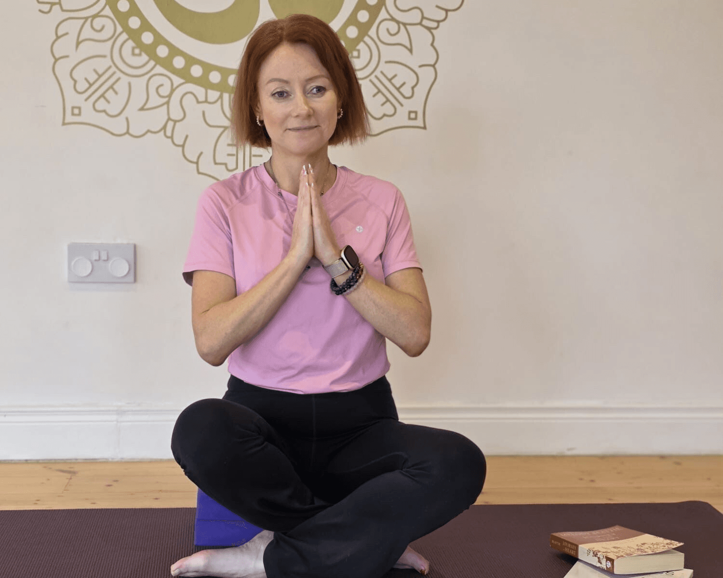 Amy Brady seated in her yoga studio